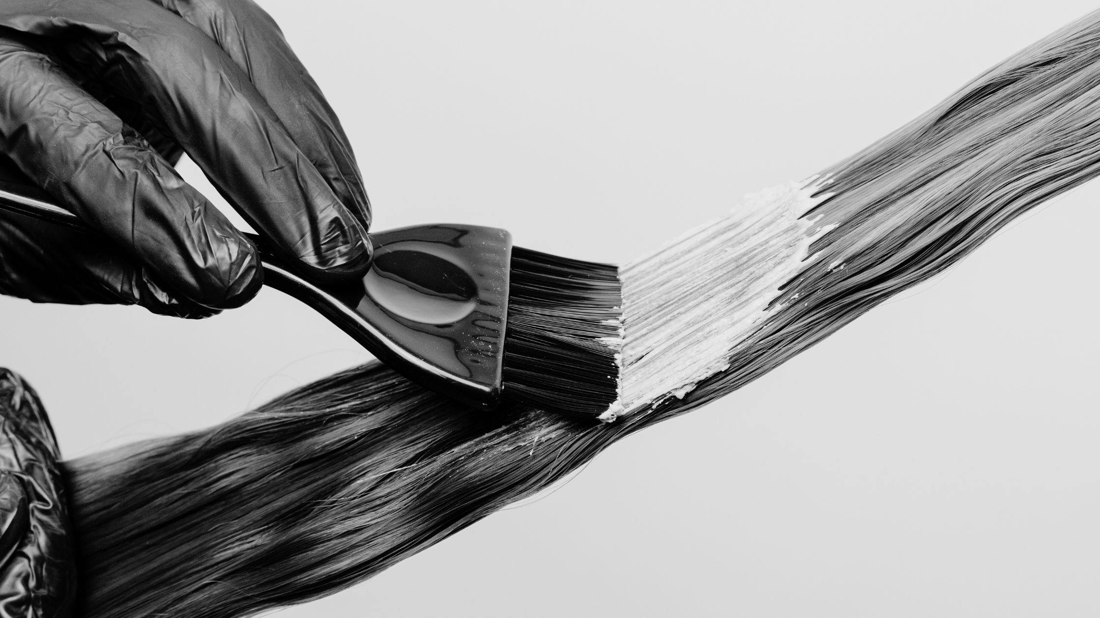 colorist applying color to hair
